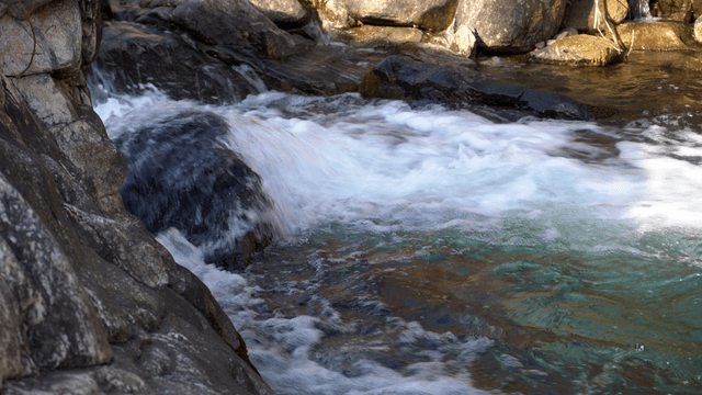 Fast-flowing river with clear water and rocks