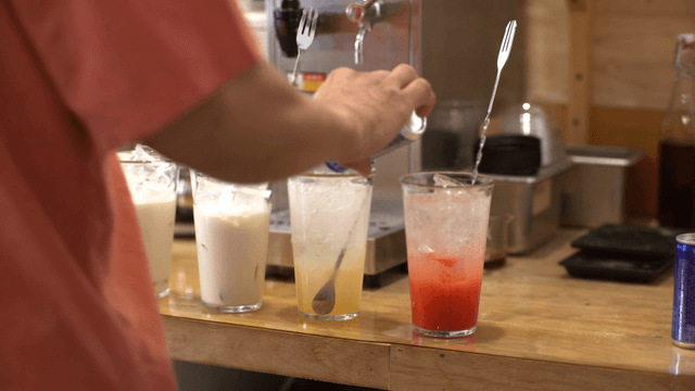 Preparing various iced drinks on a counter