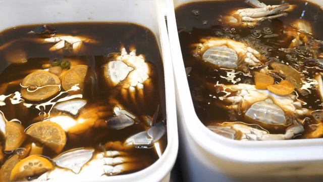 Soy sauce marinated crabs in containers