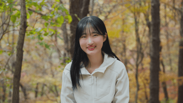 Young woman smiling in autumn forest