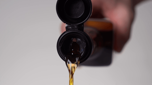 Pouring sauce from a bottle