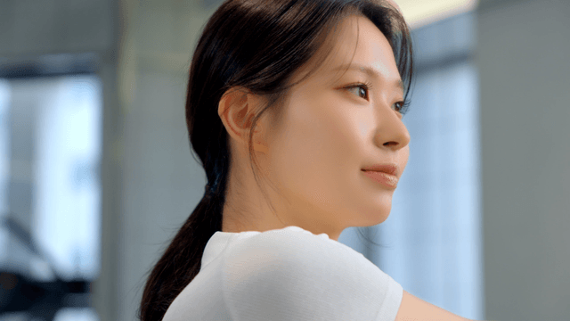 Young woman stretching indoors with focus