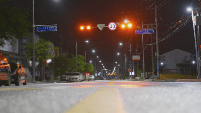 Quiet empty road with streetlights on