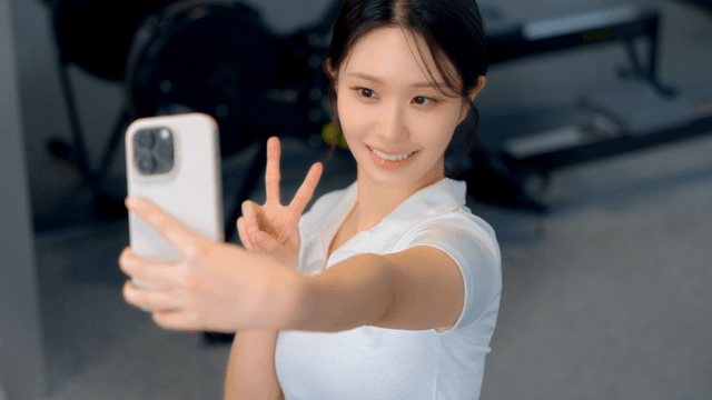 Young woman taking a selfie at the gym