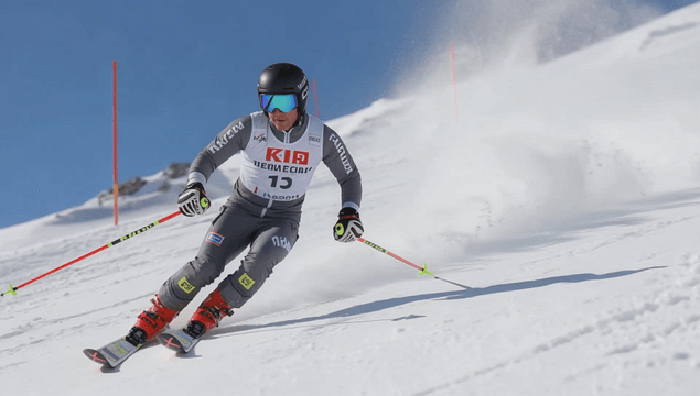 A skier racing down a snowy slope