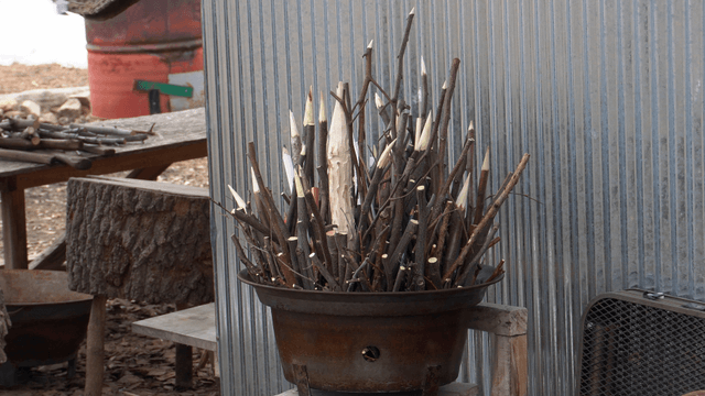 Metal basket filled with sharpened wooden carvings