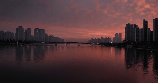 City skyline at sunset with a river view