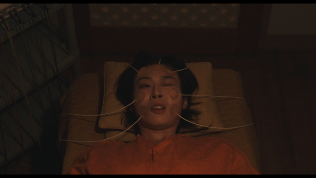 Woman receiving Korean medicine low-frequency therapy on face