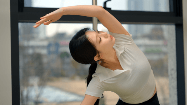 Woman stretching by the window