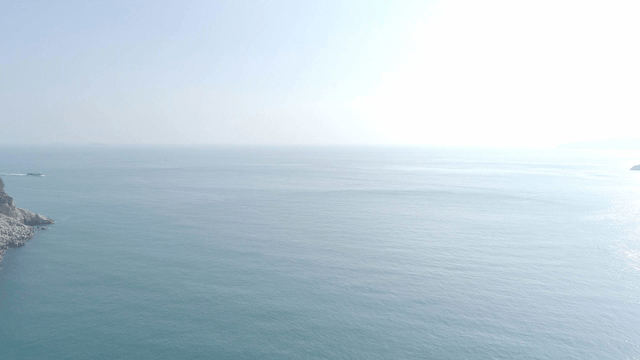 Vast ocean with distant cliffs