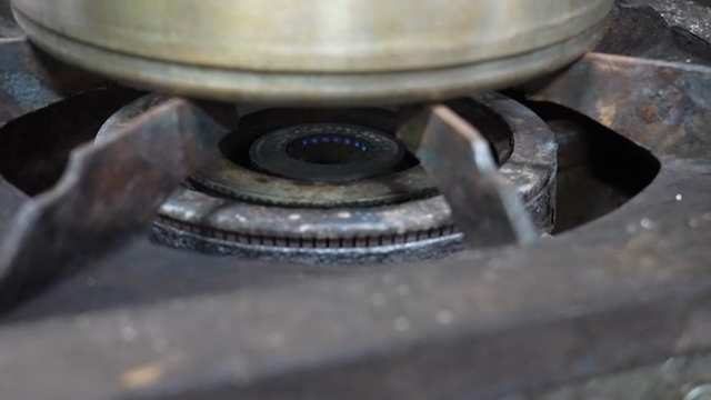 Turning off the flame on a gas stove