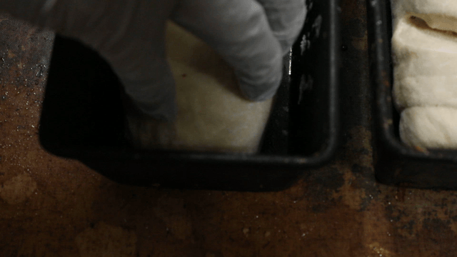 Dough being placed into a baking pan