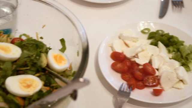 A table set with salad, bread, and cheese