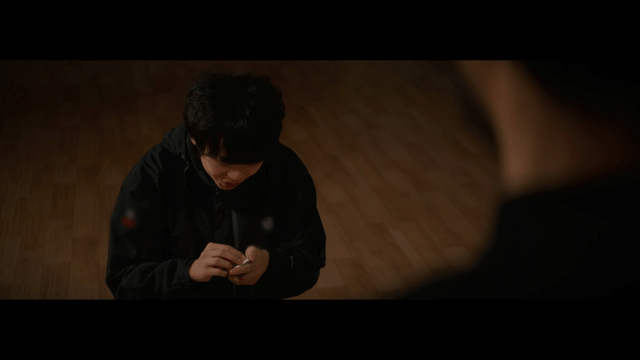 Man removing a sticker from a device indoors