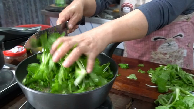 Chopping and adding greens to a pot
