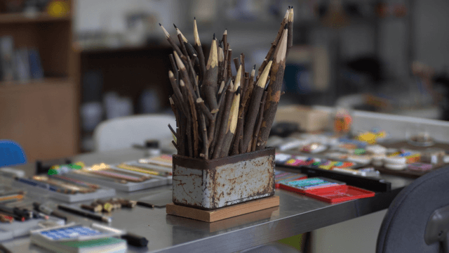 Wooden branch pencil sculpture on art activity table