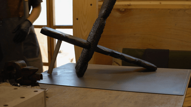 Craftsman working on a wooden sculpture