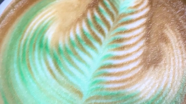 Intricate latte art on a creamy coffee
