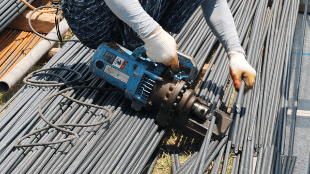 Worker using a rebar cutter on site