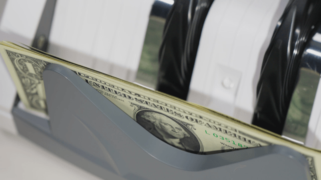 Counting machine processing dollar bills