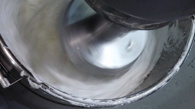 Mixing cream and butter in a metal bowl