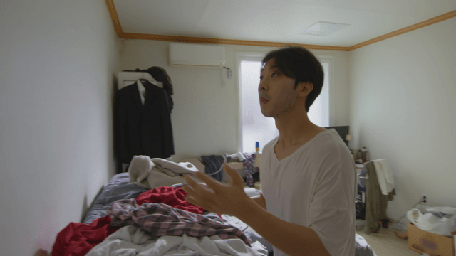 Man catching a bug in a messy room