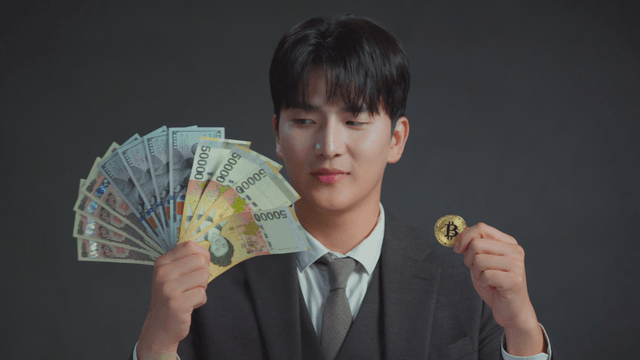 Man smiling at the Bitcoin in his hand