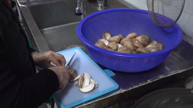 Slicing mushrooms in a kitchen