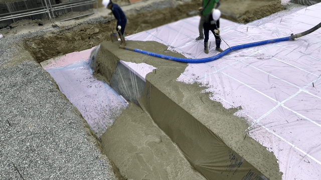 Construction workers pouring concrete