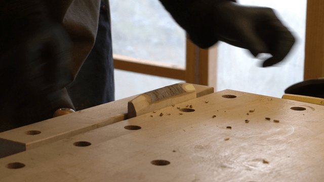 Artisan carving wood with a precision chisel