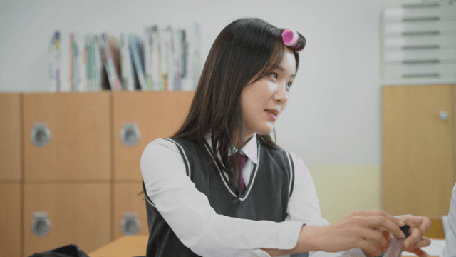 Student with hair roller talking in class