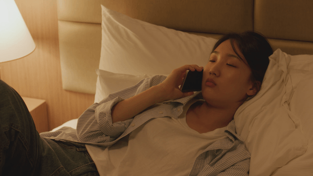 Woman talking on the phone in bed