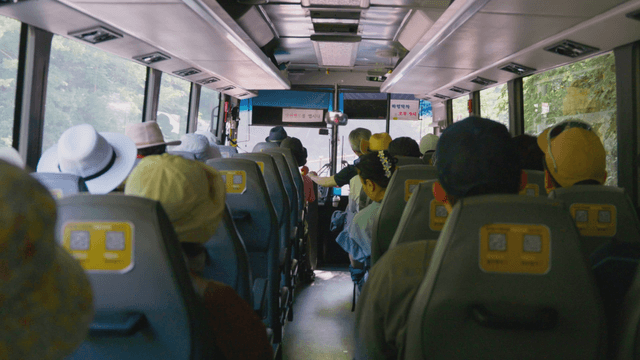 Passengers swaying inside bus driving on mountain road