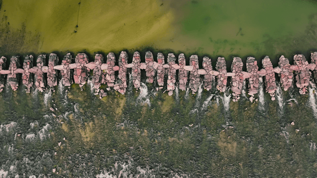 Aerial view of a stone bridge over a blue river