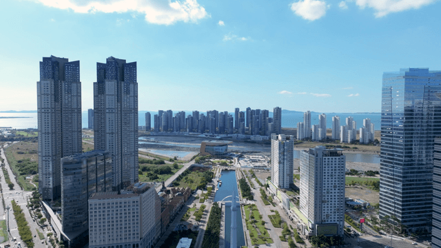 Modern cityscape with tall buildings by the sea