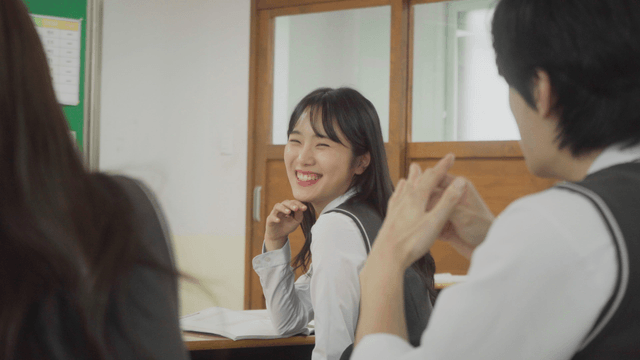 Students smiling and chatting together in the classroom
