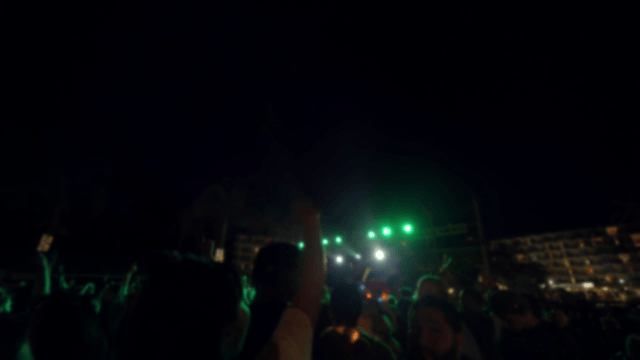 Nighttime outdoor concert with a crowd