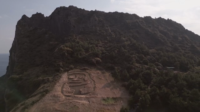 A scenic mountain with a carved field