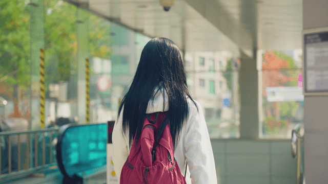 Woman with backpack heading to subway