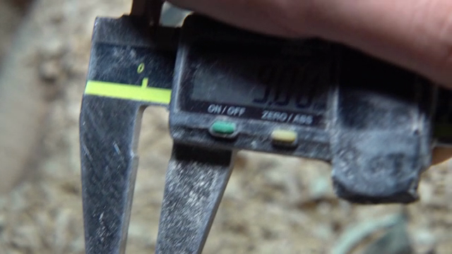 Caliper measuring a wooden object