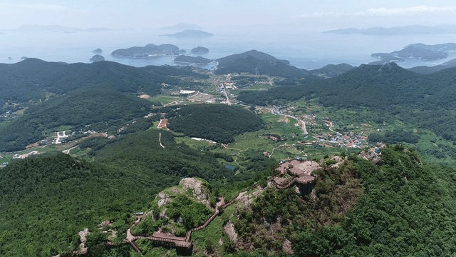 Mountain top view with city and sea
