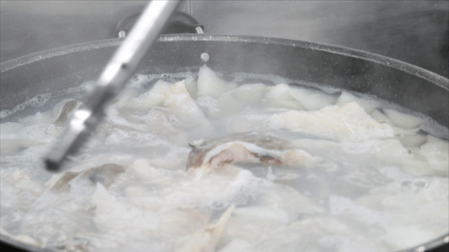 Boiling cod soup in large pot