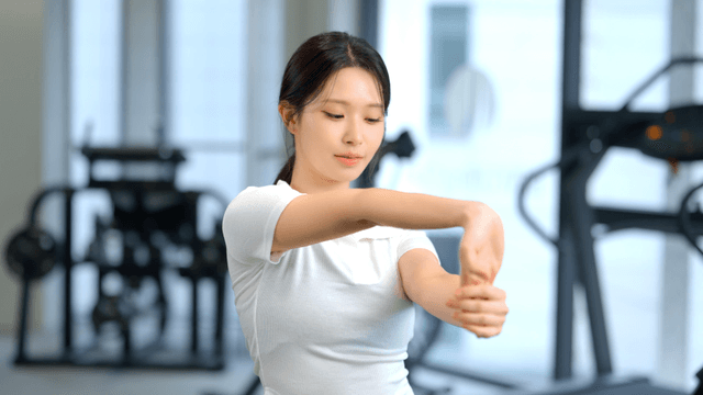 Woman stretching arms at gym