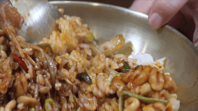 Seasoned codfish bibimbap mixed in a metal bowl