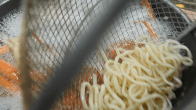 Noodles Being Added to Boiling Crab in Pot