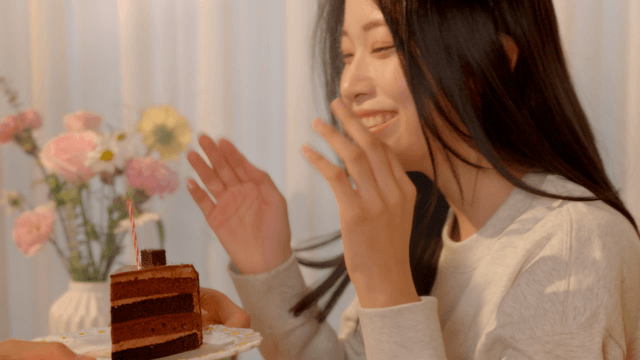 Young girlfriend blowing cake candles with happiness