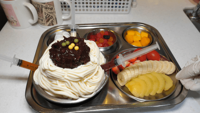 A unique dessert with syringes and fruits