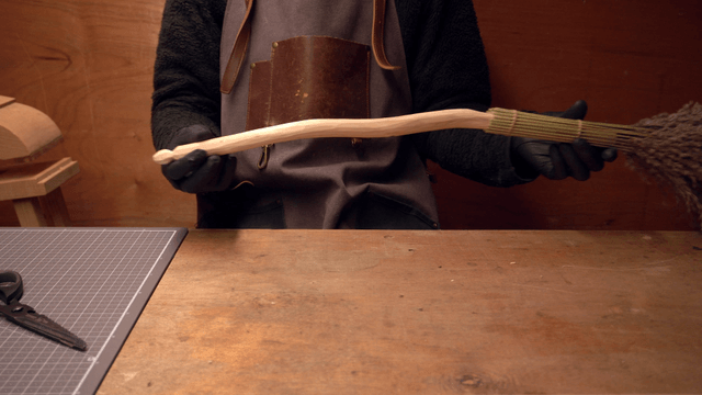 Person crafting a handmade broom