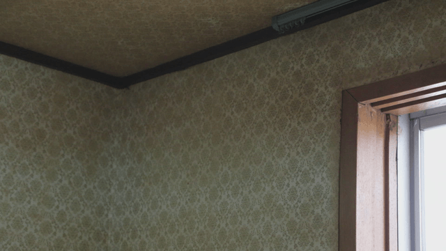 Old corner with patterned wallpaper
