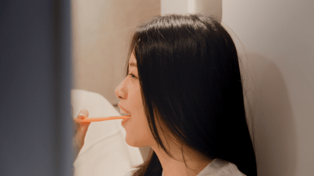 Couple brushing teeth playfully together